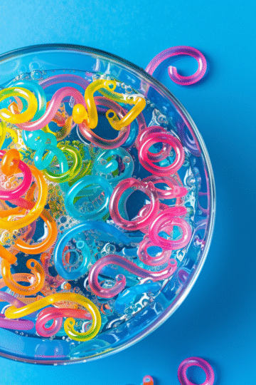 u3929625643 Colorful curled paper worms moving across a shall aceb1028 e625 46c1 876d 7e424eead81e 1